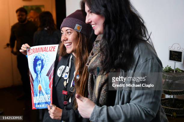 Amy Webb, left, and Miranda Cummings pose with a decriminalize mushrooms poster at an election watch party in support of Ordinance 301 on May 7, 2019...