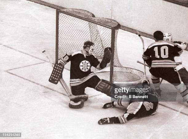 Goalie Gerry Cheevers of the Boston Bruins makes the save as his teammates Bobby Orr and Carol Vadnais defend during an NHL game circa 1972.
