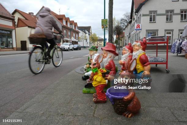 Garden gnomes stand for sale outside a store along the main shopping street in the town center on April 11, 2019 in Tangerhutte, Germany. Tangerhutte...