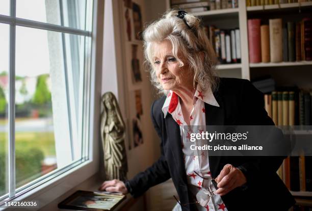 April 2019, Berlin: EXCLUSIVE - Helga Piur, actress, stands by her library in her study. Photo: Britta Pedersen/dpa-Zentralbild/ZB