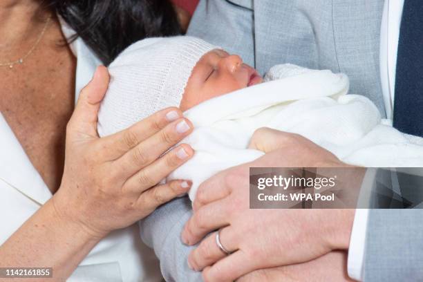 Prince Harry, Duke of Sussex and Meghan, Duchess of Sussex, pose with their newborn son Archie Harrison Mountbatten-Windsor during a photocall in St...