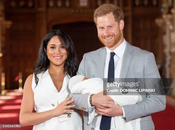 Britain's Prince Harry, Duke of Sussex , and his wife Meghan, Duchess of Sussex, pose for a photo with their newborn baby son, Archie Harrison...