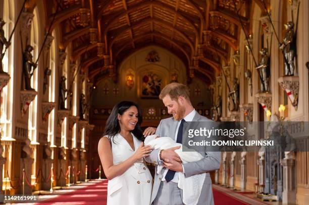 Britain's Prince Harry, Duke of Sussex , and his wife Meghan, Duchess of Sussex, pose for a photo with their newborn baby son, Archie Harrison...
