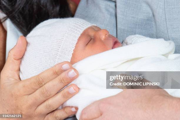 Britain's Prince Harry, Duke of Sussex , and his wife Meghan, Duchess of Sussex, pose for a photo with their newborn baby son, Archie Harrison...