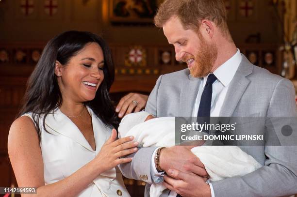 Britain's Prince Harry, Duke of Sussex , and his wife Meghan, Duchess of Sussex, pose for a photo with their newborn baby son, Archie Harrison...