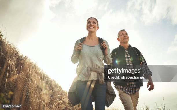 life’s better enjoyed with a side of adventure - active lifestyle couple stock pictures, royalty-free photos & images