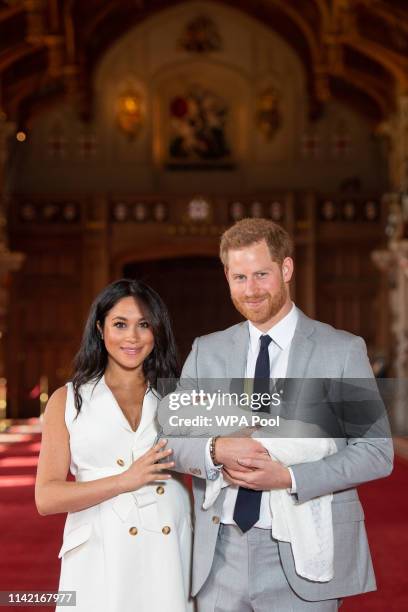 Prince Harry, Duke of Sussex and Meghan, Duchess of Sussex, pose with their newborn son Archie Harrison Mountbatten-Windsor during a photocall in St...