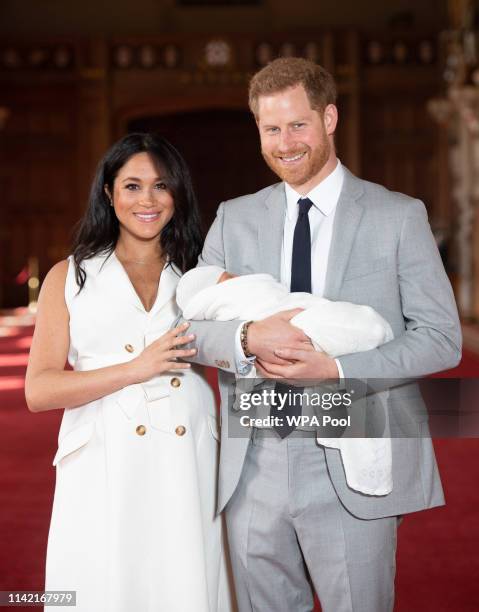 Prince Harry, Duke of Sussex and Meghan, Duchess of Sussex, pose with their newborn son Archie Harrison Mountbatten-Windsor during a photocall in St...