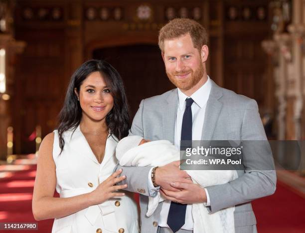 Prince Harry, Duke of Sussex and Meghan, Duchess of Sussex, pose with their newborn son Archie Harrison Mountbatten-Windsor during a photocall in St...