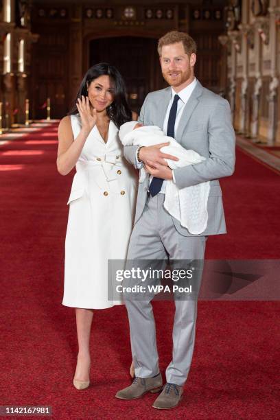 Prince Harry, Duke of Sussex and Meghan, Duchess of Sussex, pose with their newborn son Archie Harrison Mountbatten-Windsor during a photocall in St...