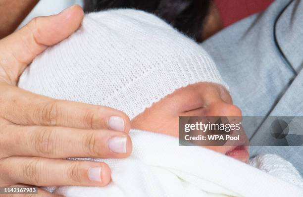 Prince Harry, Duke of Sussex and Meghan, Duchess of Sussex, pose with their newborn son Archie Harrison Mountbatten-Windsor during a photocall in St...