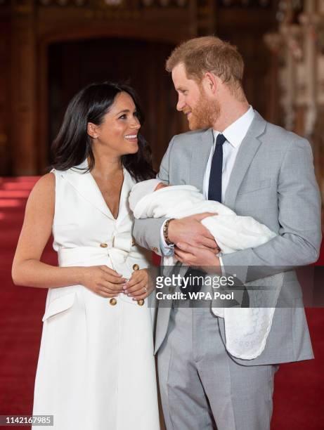 Prince Harry, Duke of Sussex and Meghan, Duchess of Sussex, pose with their newborn son Archie Harrison Mountbatten-Windsor during a photocall in St...