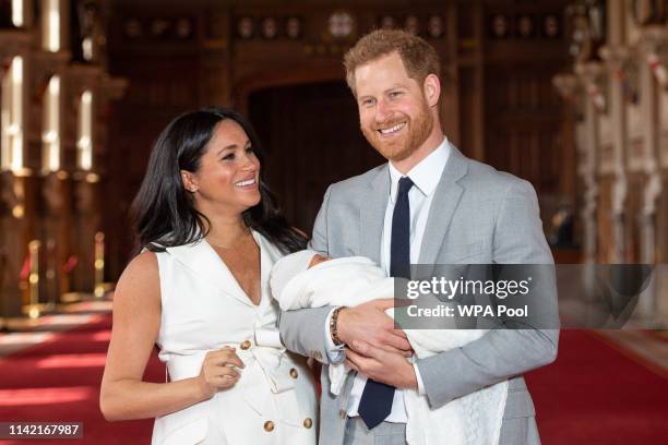 Prince Harry, Duke of Sussex and Meghan, Duchess of Sussex, pose with their newborn son Archie Harrison Mountbatten-Windsor during a photocall in St...