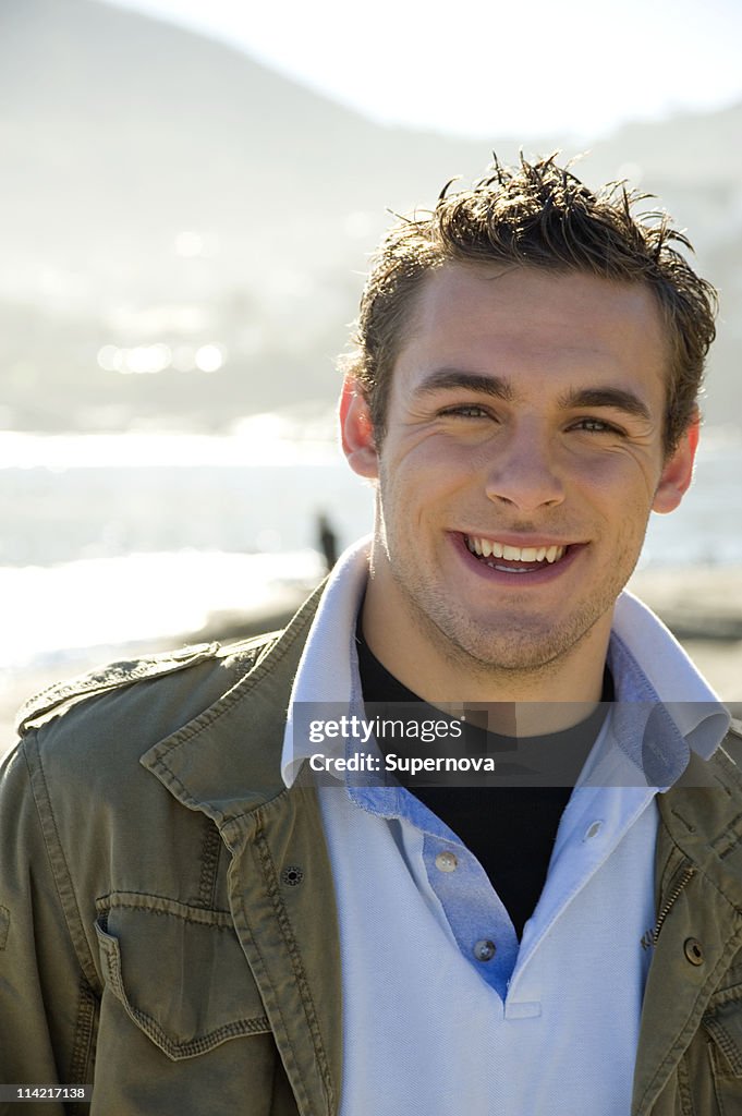 Portrait of young man smiling to camera, Bakoven, Cape Town, Western Cape Province, South Africa
