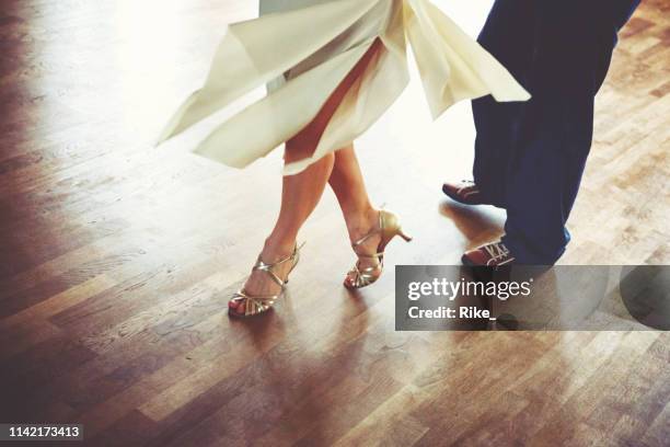 dancing couple in the light dance hall - ballroom dance stock pictures, royalty-free photos & images