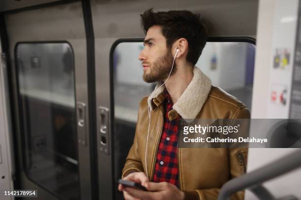 a 30 years old man in the subway - paris millenials stock-fotos und bilder
