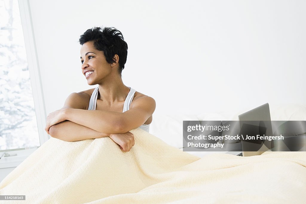 Mid adult woman sitting on the bed