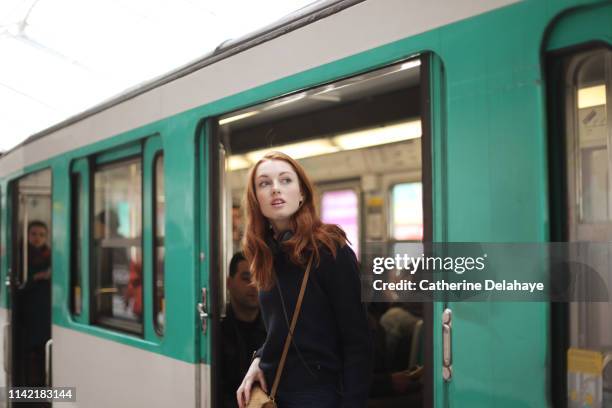 portrait of a young woman in the subway in paris - underground rail stockfoto's en -beelden
