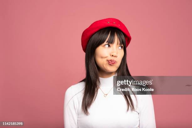 asian girl - pink hat stock pictures, royalty-free photos & images