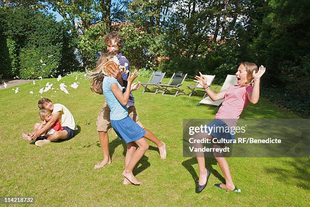 boy throws at girl a cream cake as a joke - girl sitting on boys face fotografías e imágenes de stock