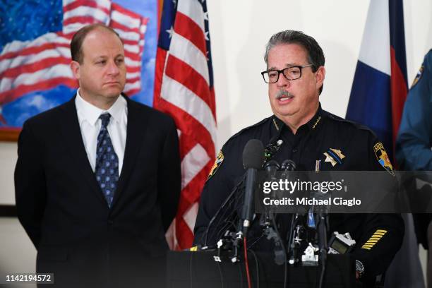 Colorado governor Jared Polis , looks on as Douglas County sheriff Tony Spurlock speaks to the media regarding the shooting at STEM School Highlands...