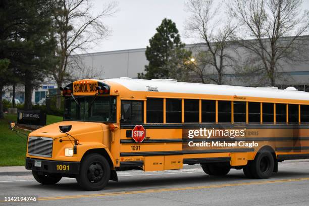 School bus drives past the entrance to the STEM School Highlands Ranch on May 8, 2019 in Highlands Ranch, Colorado, one day after a shooting there...