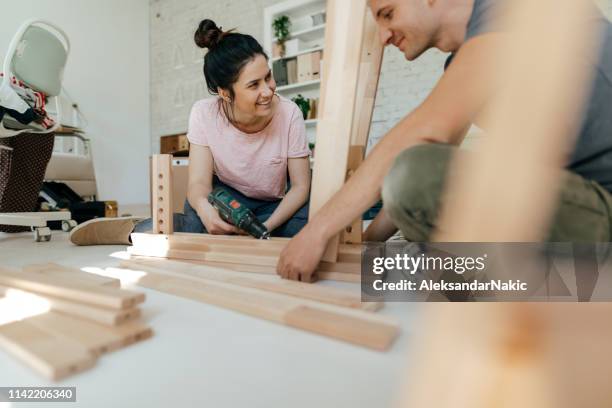 couple assembling furniture together - woman make up stock pictures, royalty-free photos & images