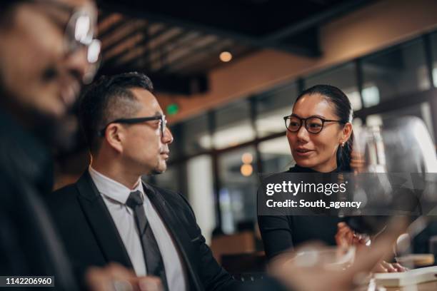 chinese mensen zaken in restaurant - business chinese men talking stockfoto's en -beelden