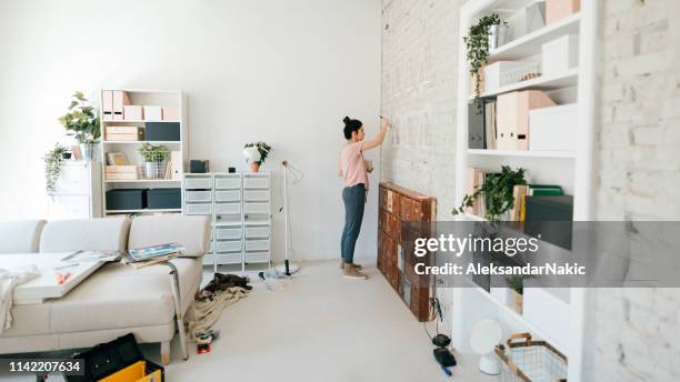 painting walls of new apartment - messy living room stock pictures, royalty-free photos & images