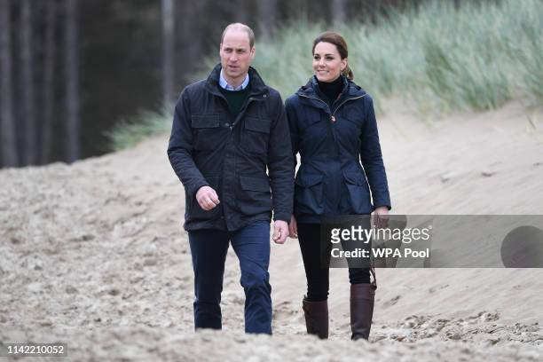 Prince William, Duke of Cambridge and Catherine, Duchess of Cambridge on a visit to Newborough Beach where they met the Menai Bridge Scouts and...