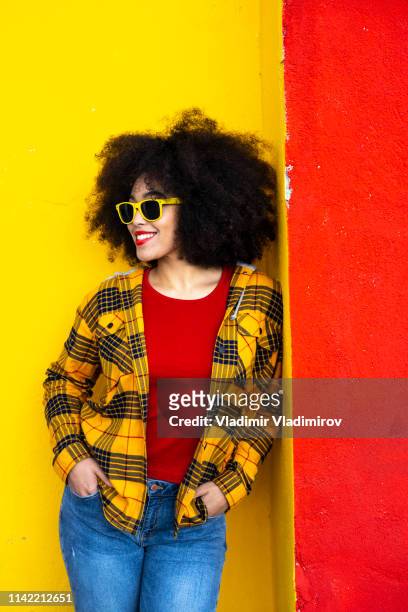 woman in yellow shirt and yellow sunglasses - curly red hair glasses stock pictures, royalty-free photos & images