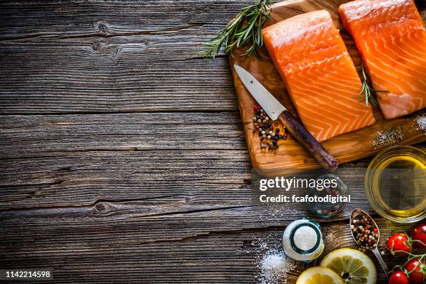 two raw salmon fillets ready for cooking shot from above with copy space - rustic salmon fillets stock pictures, royalty-free photos & images