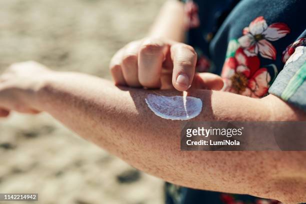 it reduces the appearance of sun damage - freckle arm stock pictures, royalty-free photos & images