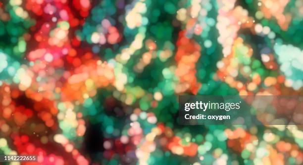 abstract red and green bokeh sparkling spray circle - green christmas designs stock pictures, royalty-free photos & images