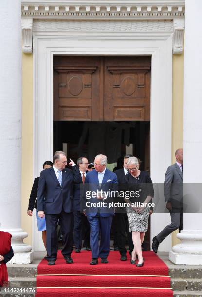 May 2019, Saxony-Anhalt, Wörlitz: The British heir to the throne, Prince Charles , leaves Wörlitz Castle accompanied by Foundation President Brigitte...