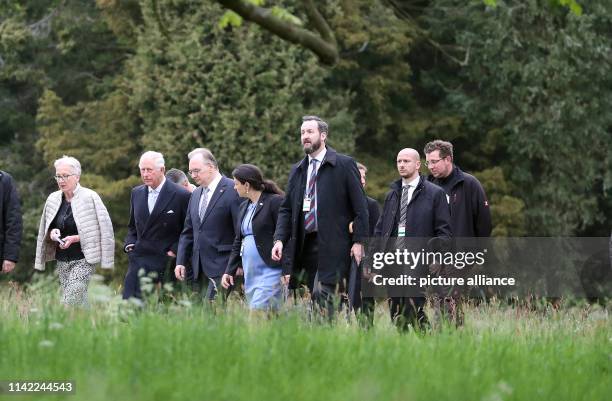 May 2019, Saxony-Anhalt, Wörlitz: The British heir to the throne Prince Charles walks along a path in the Garden Kingdom of Dessau-Wörlitz with...