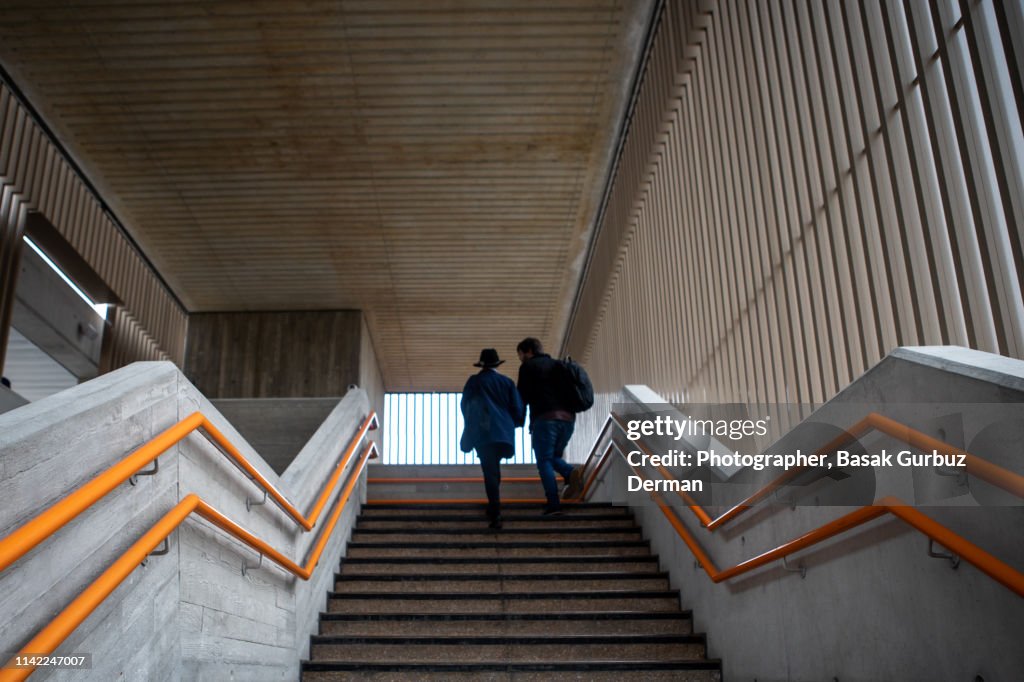 Low angle view of a woman and a man moving up the steps