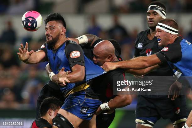 Henry Stowers of the Force offloads the ball while being tackled by Kali Hala and Nili Latu of the Dragons during the Rapid Rugby match between the...