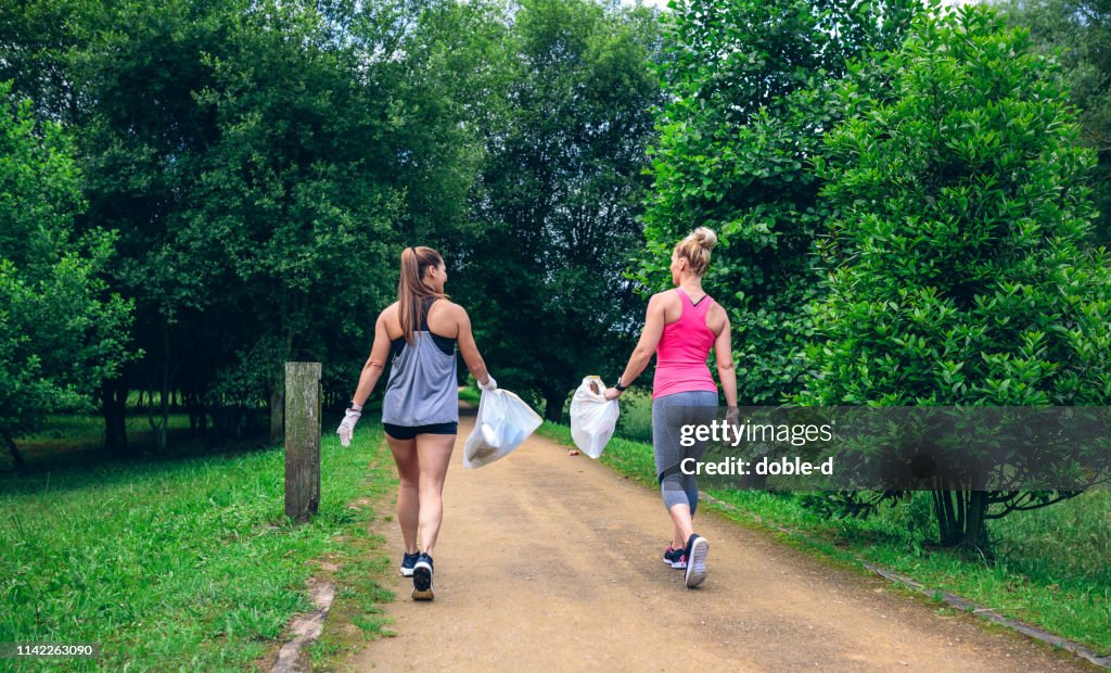Two girls on back doing plogging