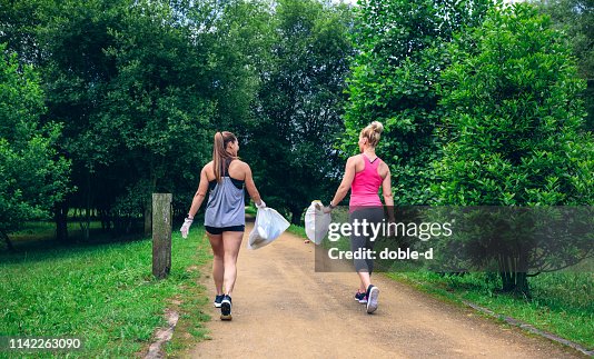Two girls on back doing plogging Two girls on back doing plogging