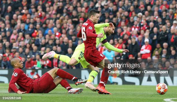 Barcelona's Lionel Messi goes down under the challenge from Liverpool's Fabinho and Andrew Robertson during the UEFA Champions League Semi Final...