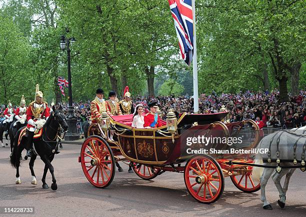 Prince William, Duke of Cambridge and Catherine, Duchess of Cambridge make the journey by carriage procession to Buckingham Palace following their...