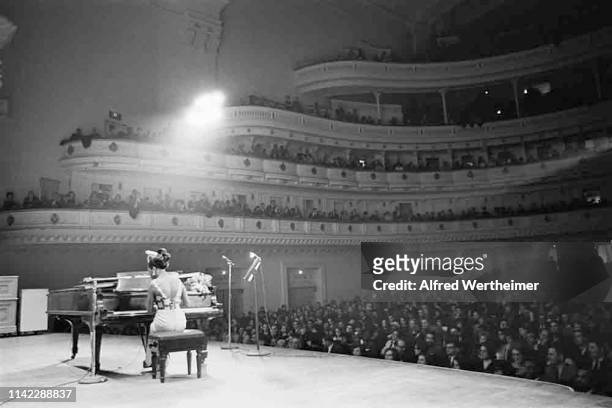 American Jazz & Blues musician and Civil Rights activist Nina Simone plays piano as she performs onstage at Carnegie Hall, New York, New York, April...