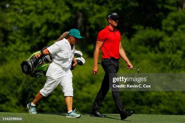 Henrik Stenson of Sweden walks with caddie Fanny Sunesson on the 12th hole during the second round of the Masters at Augusta National Golf Club on...