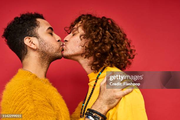 colourful studio portrait of a gay male couple - gay person color background stock pictures, royalty-free photos & images