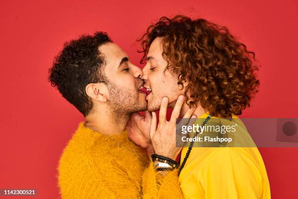 colourful studio portrait of a gay male couple - gay person color background stock pictures, royalty-free photos & images