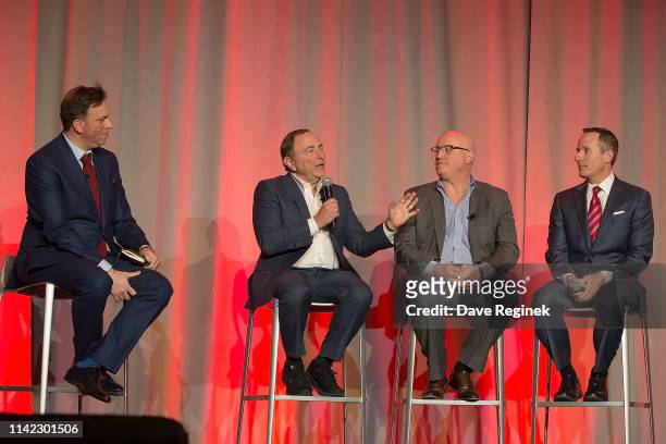 From left to right, Elliotte Friedman, Canadian sports journalist, talks with Gary Bettman, Commissioner of the National Hockey League, Bill Daly,...