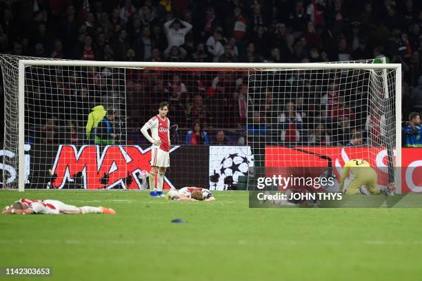 Ajax players react after losing their UEFA Champions League semi-final second leg football match against Tottenham at the Johan Cruyff Arena, in...