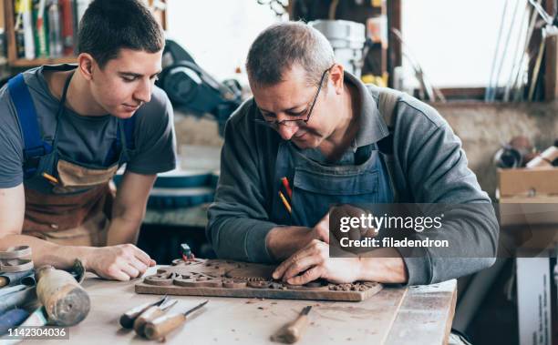 master and apprentice carpenters - carpentry apprentice stock pictures, royalty-free photos & images