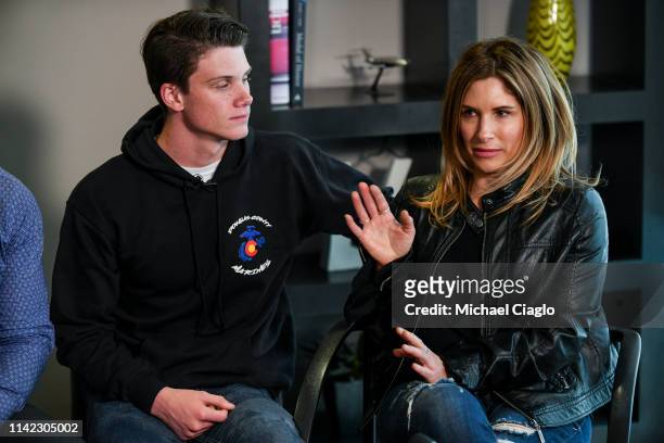 School Highlands Ranch senior Brendan Bialy, left, comforts his mother, Dena Martin, right, as she speaks to the media on May 8, 2019 in Englewood,...